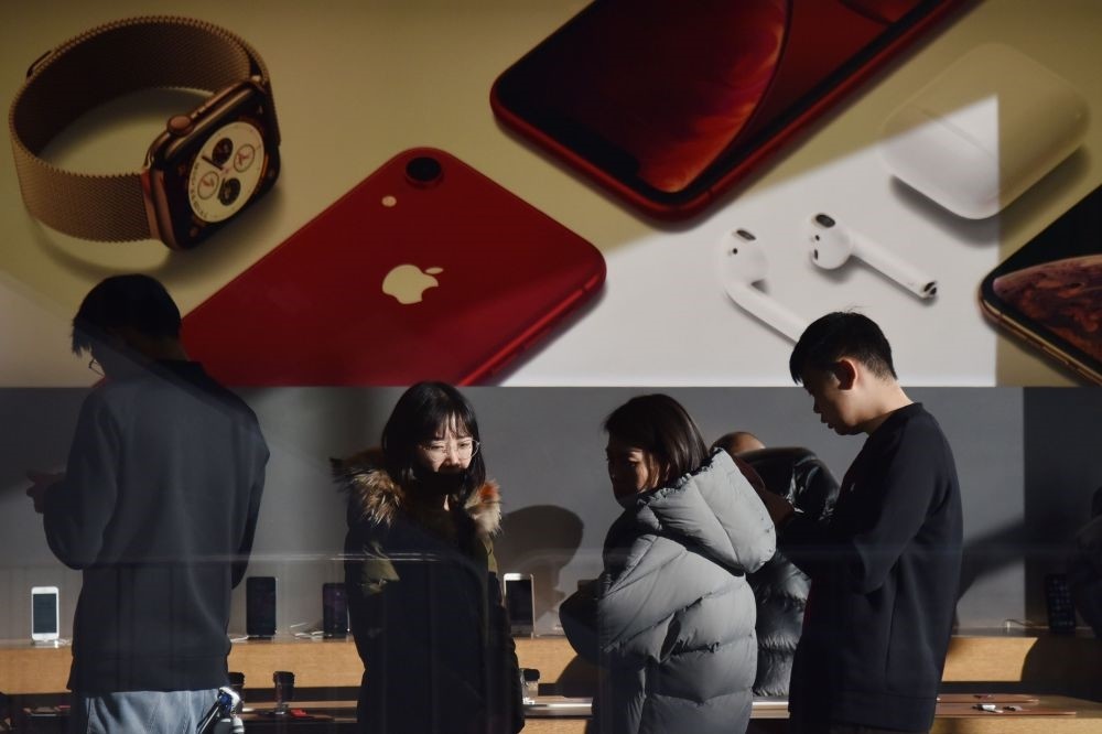 Customers look at products in an Apple store in Beijing, Dec. 11.