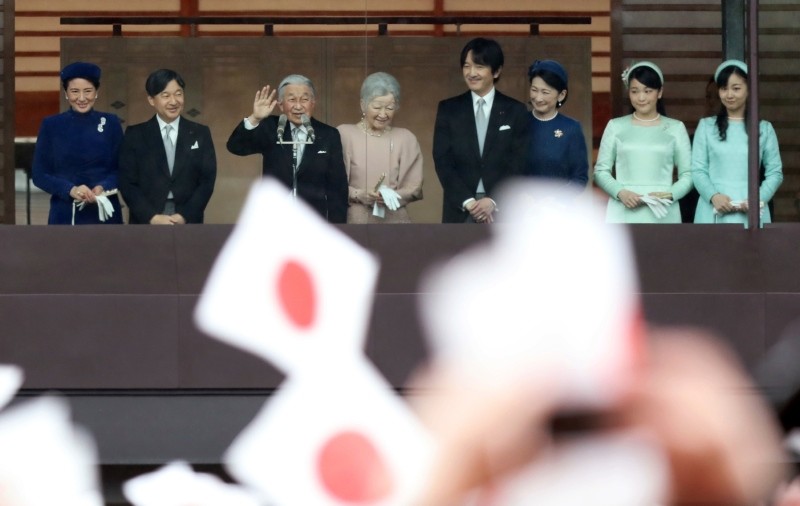 Japan's Emperor Akihito (3L), accompanied by his wife Empress Michiko and their family members, waves to well-wishers as they appear on the balcony of the Imperial Palace to mark the emperor's 85th birthday in Tokyo Sunday, Dec. 23, 2018. (AP Photo)