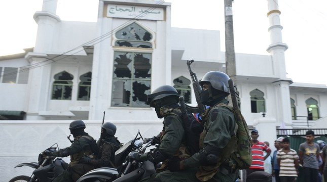 Heavily-armed Sri Lankan soldiers ride a motorcycle in front of the Jumha Mosque after a mob attack in Minuwangida on May 14, 2019. (AFP Photo)