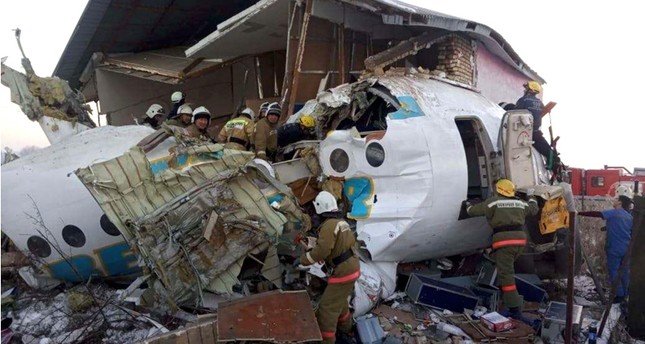 police and rescuers work on the side of a plane crash near Almaty International Airport, outside Almaty, Kazakhstan, Friday, Dec. 27, 2019. (Emergency Situations Ministry of the Republic of Kazakhstan photo via AP)