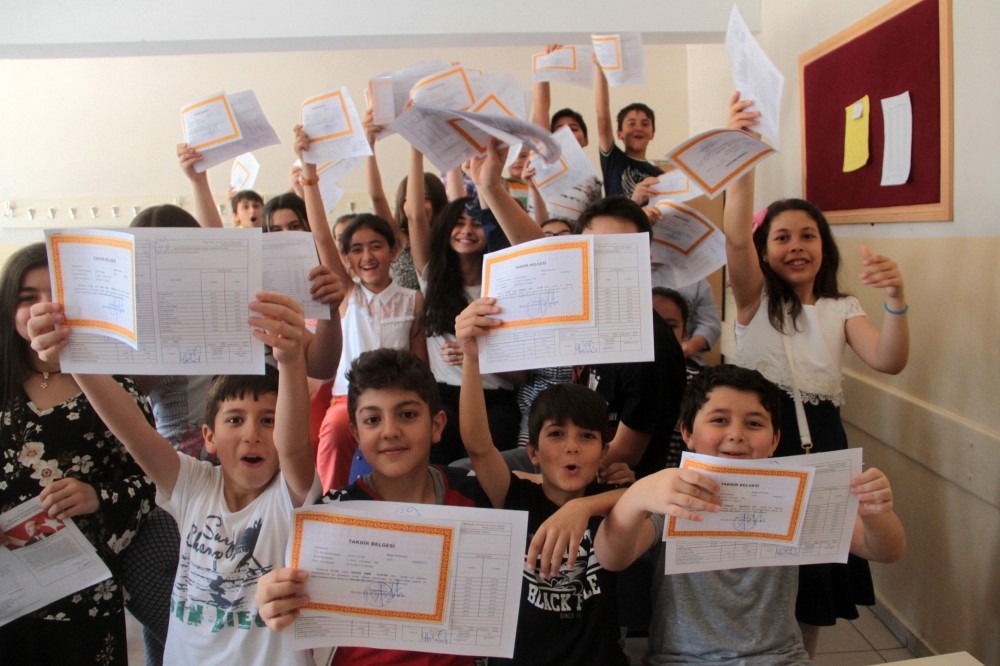 Young students at a school in the eastern city of Elazu0131u011f show their report cards.