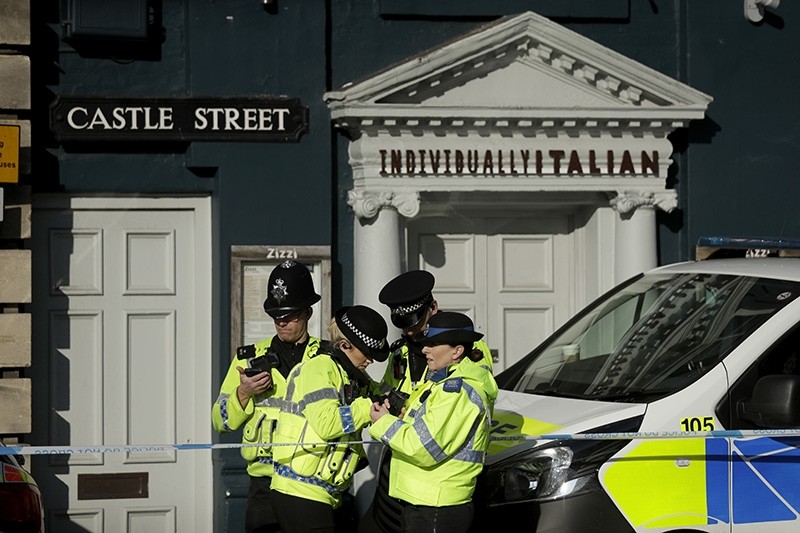 Police officers stand outside a Zizzi restaurant in Salisbury, England, Wednesday, March 7, 2018, near to where former Russian double agent Sergei Skripal was found critically ill. (AP Photo)