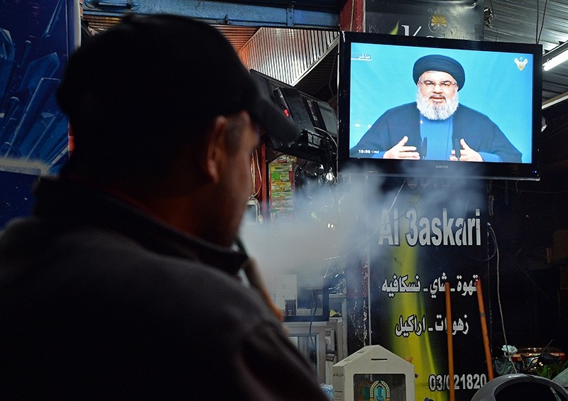 A supporter of Hezbollah watches the speech of leader Hassan Nasrallah on a screen at a cafe in Beirut, Lebanon, on November 5, 2017. (EPA Photo)