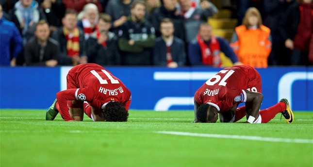 Liverpool’s Mohamed Salah, left, and his teammate Sadio Mane performing sujood, or prostrating in Muslim prayer, during the UEFA Champions League Group E match between Liverpool and Sevilla at Anfield.Liverpool, U.K.