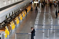 In This Sept. 5, 2014 file photo a passenger makes a phone call near-empty Lufthansa counters when pilots of Lufthansa went on a six hours warning strike at the airport in Frankfurt, Germany. (AP Photo)