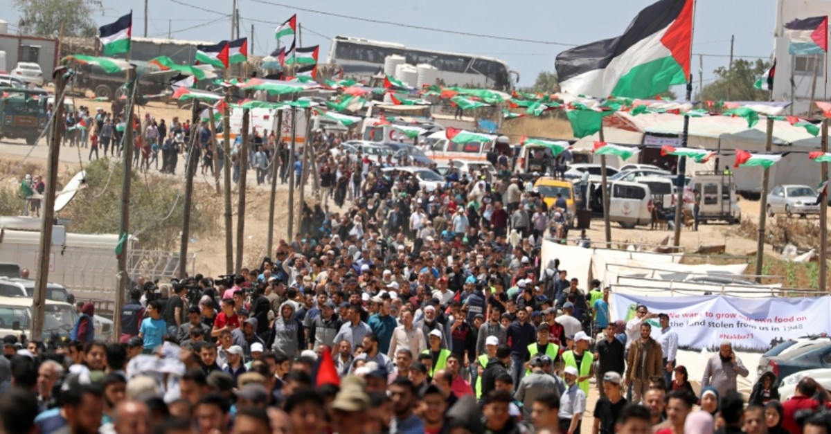 Palestinians gather to mark the 71st anniversary of the 'Nakba,' when hundreds of thousands were forced from their homes in the war surrounding Israel's independence in 1948, near the Israel-Gaza border, east of Gaza City, May 15, 2019. (Reuters)