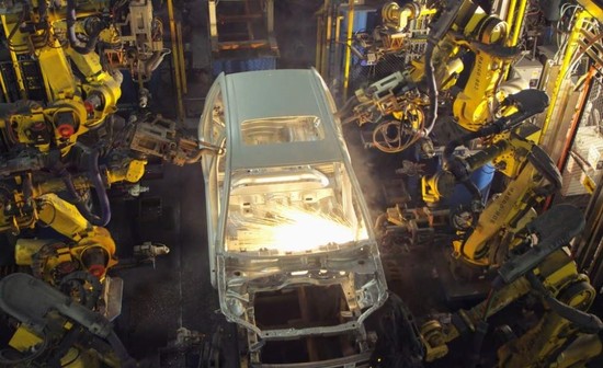FANUC robots on a GM assembly line.