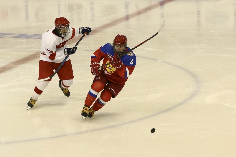 Nikolai Burenov of Russia tackles Turkish rival Emre Turan in boysu2019 ice hockey event.