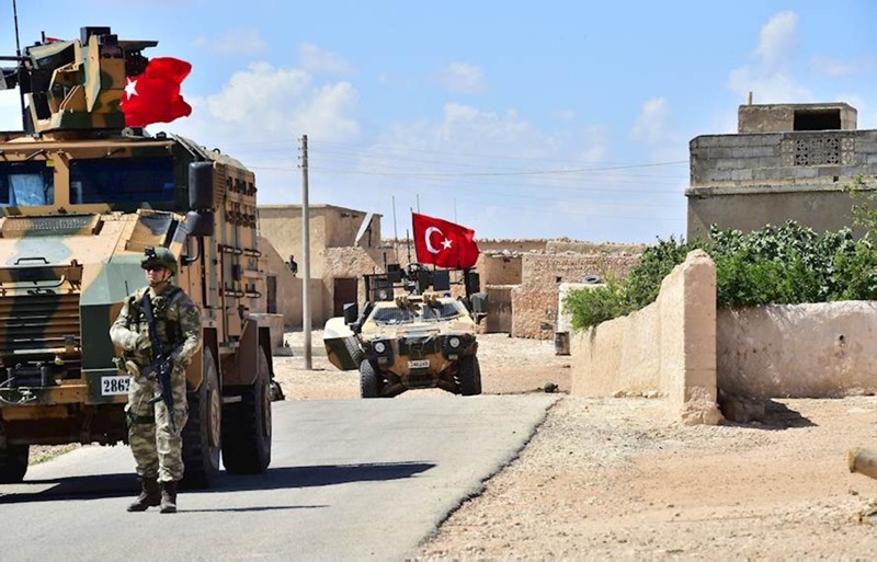 A handout picture released by the Turkish Armed Forces shows Turkish soldiers accompanied by armored vehicles patrolling between the town of Manbij in northern Syria and an area it controls after a 2016 military incursion on June 18, 2018.