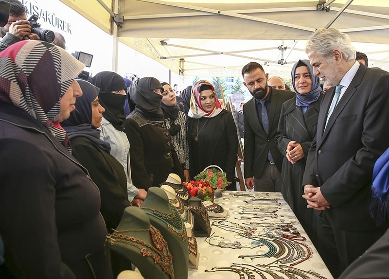 Turkish Family and Social Affairs Minister Fatma Betu00fcl Sayan Kaya (2ndR) and EU Commissioner for Humanitarian Aid and Crisis Management Christos Stylianides (R) visit a handmade jewellery stand of Syrian women, Oct. 17, in Ankara, Turkey. (AA Photo)