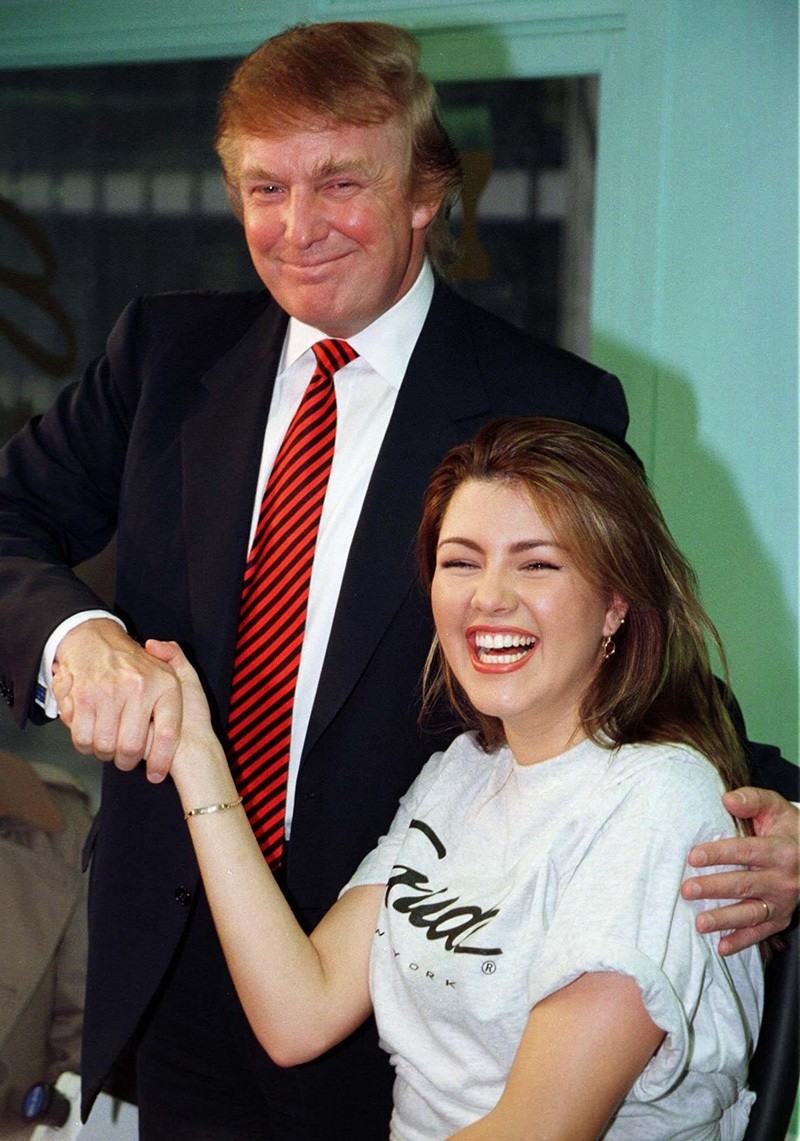 Miss Universe 1996, Alicia Machado of Venezuela, (R) is greeted by businessman Donald Trump during a staged workout at a gym in New York in a January 28, 1997 file photo. (Reuters Photo)