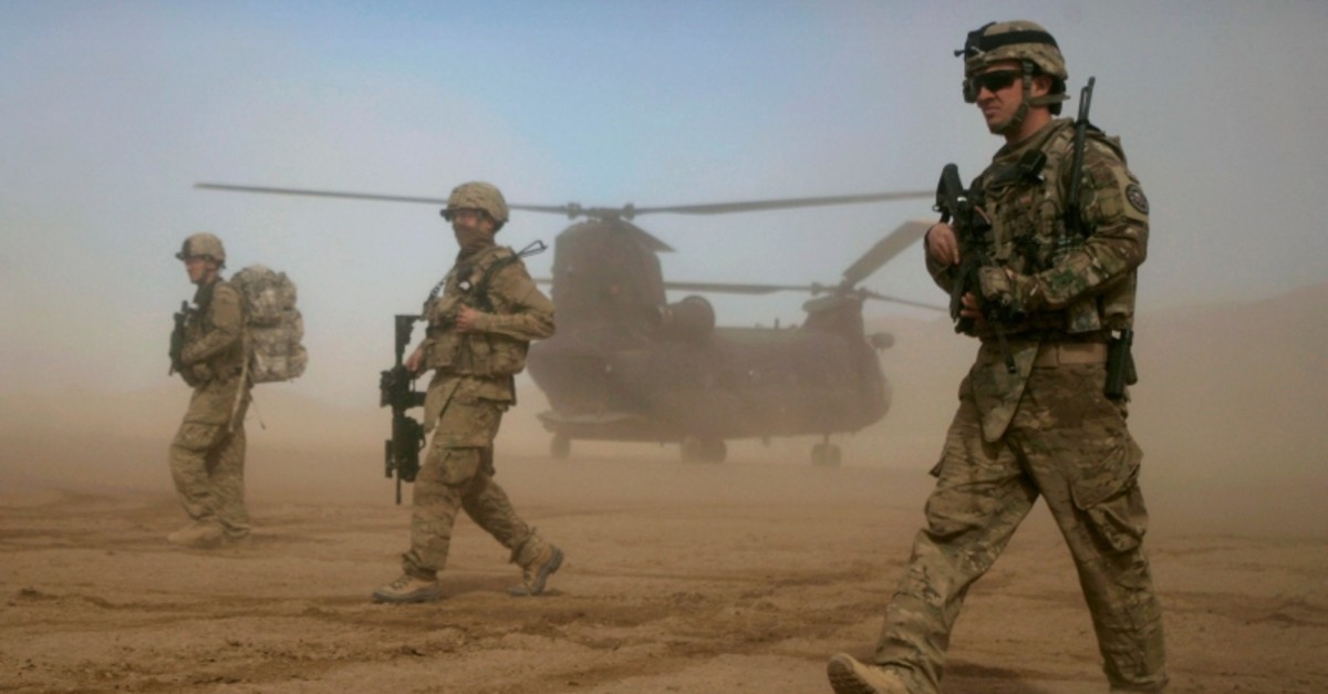 In this Saturday, Jan. 28, 2012 file photo, U.S. soldiers, part of the NATO- led International Security Assistance Force (ISAF) walk west of Kabul, Afghanistan. (AP Photo)