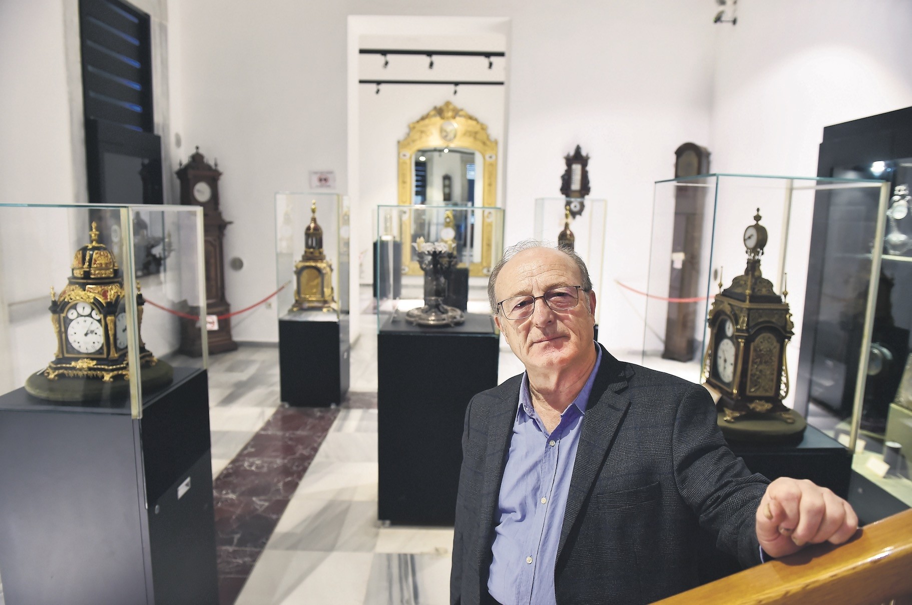 Recep Gu00fcrgen, who was trained by the clock master of Ottoman Sultan Abdu00fclhamidu2019s court, poses in the gallery where he displays antique clocks.