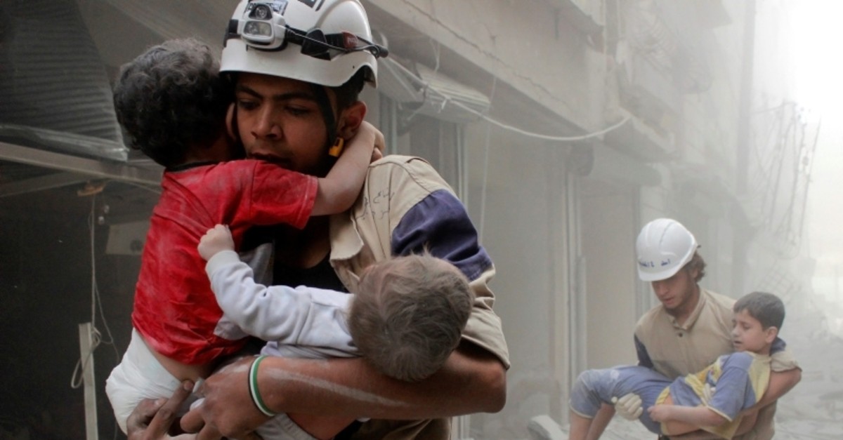 Members of the Civil Defence rescue children after what activists said was an air strike by Assad regime (Reuters File Photo)