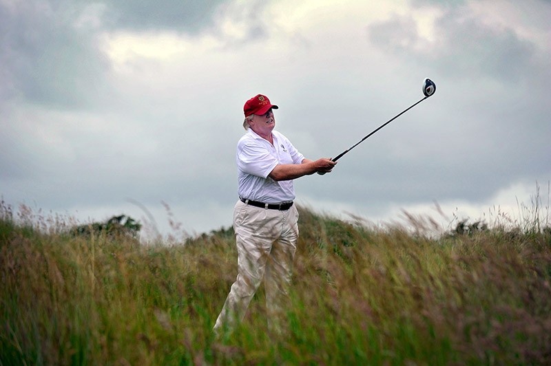 This file photo taken on July 10, 2012 shows US tycoon Donald Trump playing a stroke as he officially opens his new multi-million pound Trump International Golf Links course in Aberdeenshire, Scotland. (AFP Photo)