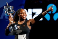 Williams holds her trophy after defeating her sister Venus during the women's singles final at the Australian Open tennis championships in Melbourne, Australia. (AP Photo)