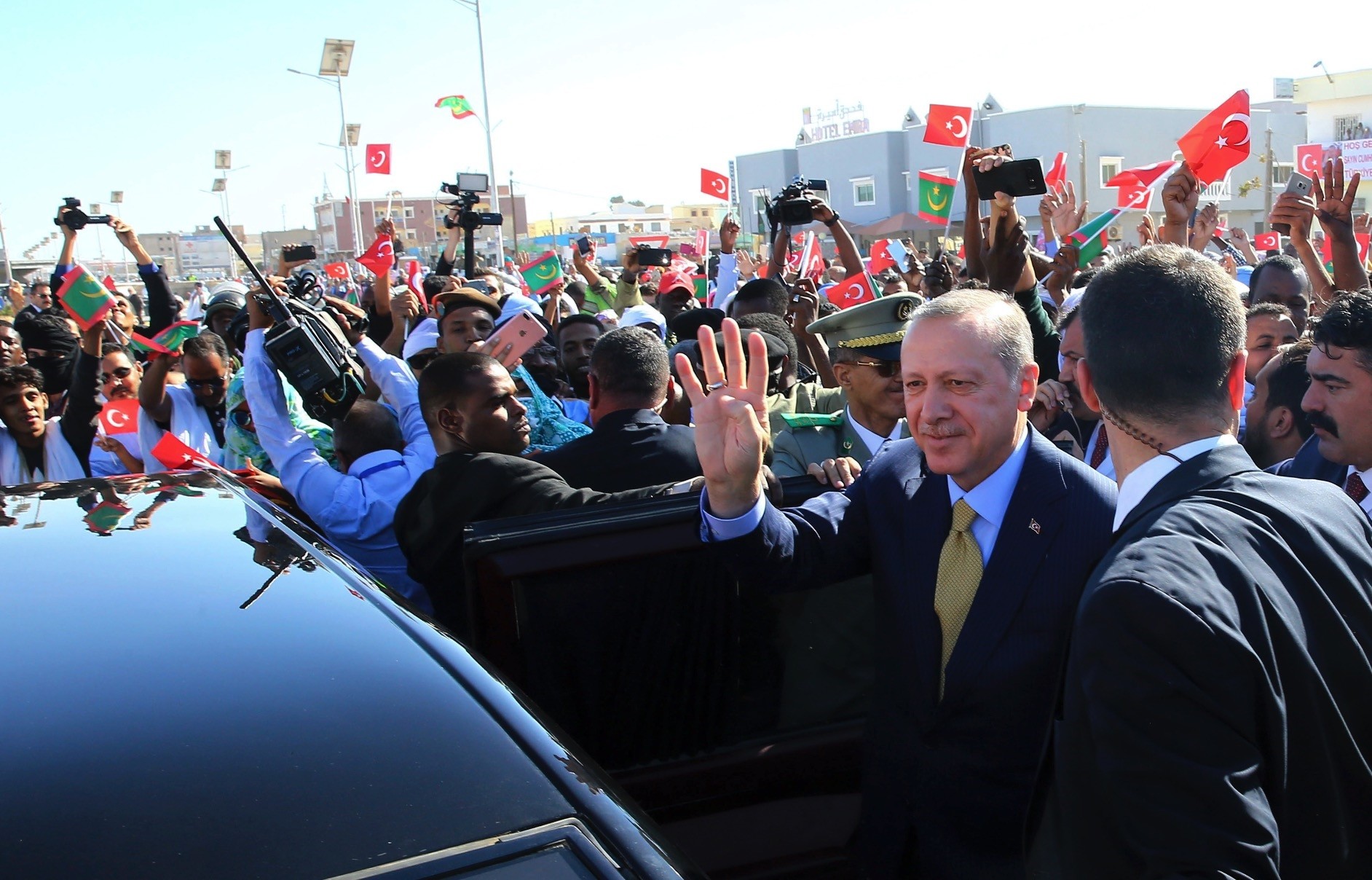Turkish and Mauritanian security and people surround the car of President Erdogan as he waves during a welcoming ceremony at the airport in Nouakchott, Mauritania, Feb. 28., 2018.