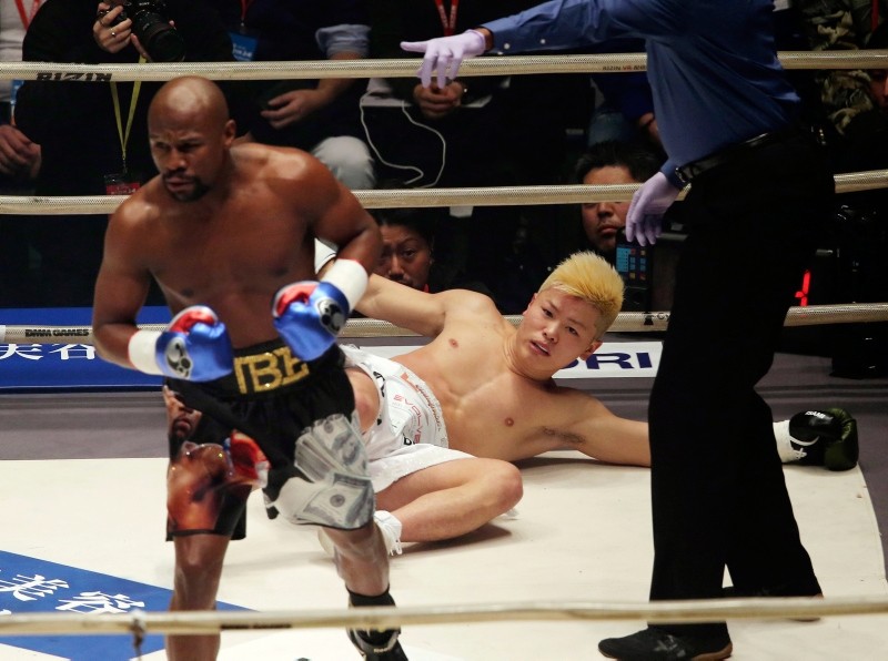 Japanese kick boxer Tenshin Nasukawa lies on the mat after being knocked out by Floyd Mayweather Jr. during first round of their three-round exhibition match, at Saitama Super Arena in Saitama, north of Tokyo, Monday, Dec. 31, 2018. (AP Photo)