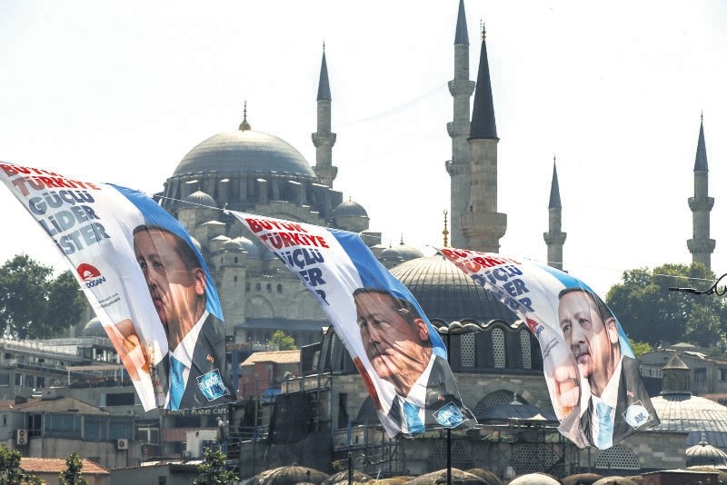 Election posters of President Recep Tayyip Erdou011fan and his ruling Justice and Development Party (AK Party) decorate a street in u0130stanbul, June 6.