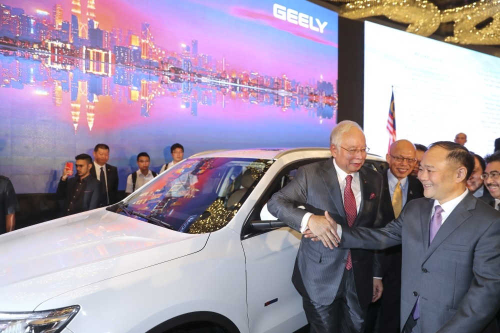 Malaysian Prime Minister Najib Razak shakes hand with Zhejiang Geely CEO Li Shufu, right, after a signing ceremony for Proton and Geely in Kuala Lumpur, Malaysia.