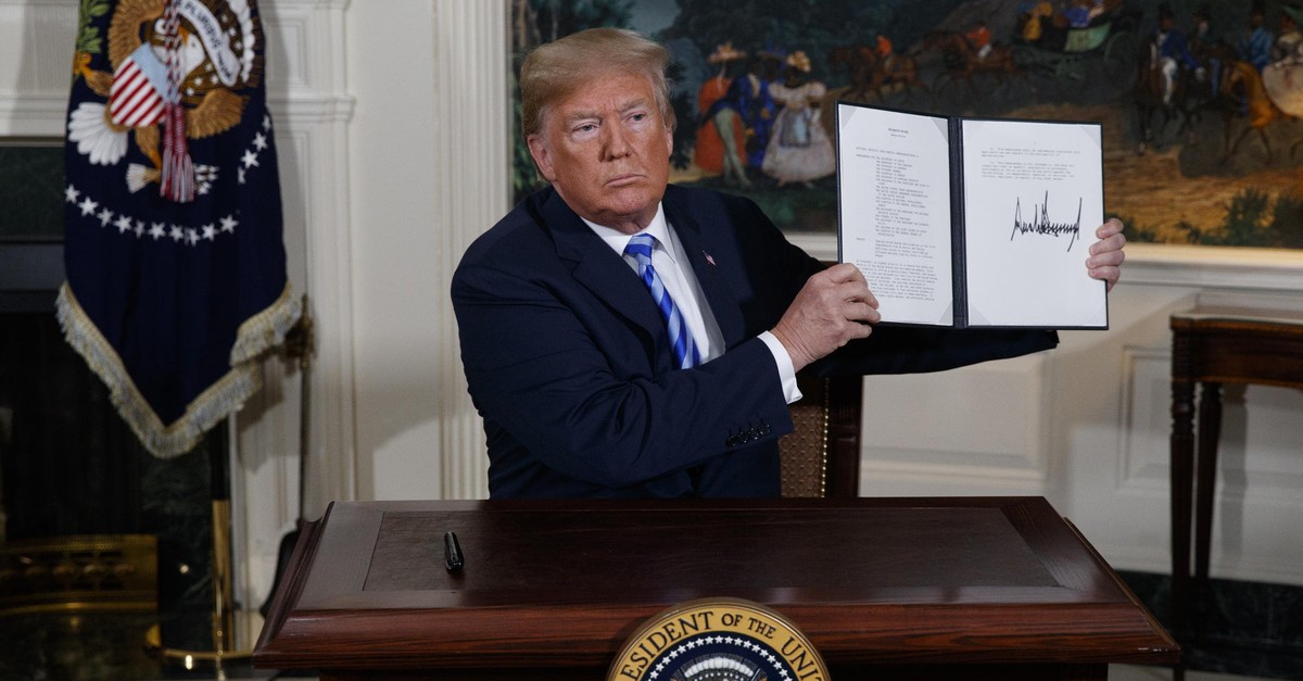 U.S. President Donald Trump signs a presidential memorandum on the Iran nuclear deal, at the White House, May 8, 2018. 