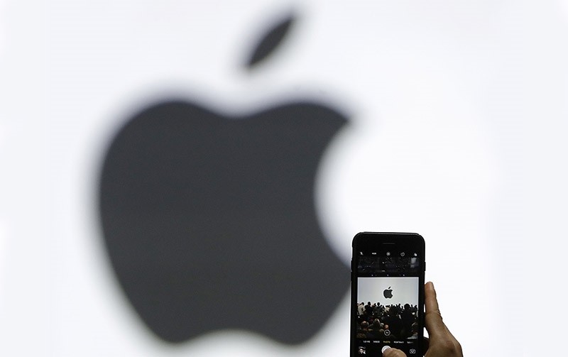 In this Monday, June 5, 2017, file photo, a person takes a photo of an Apple logo before an announcement of new products at the Apple Worldwide Developers Conference in San Jose, Calif (AP Photo)
