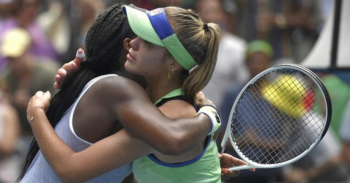 Sofia Kenin (R) is embraced by compatriot Coco Gauff after winning their fourth round singles match at the Australian Open tennis championship, Melbourne, Jan. 26, 2020. (AP Photo)