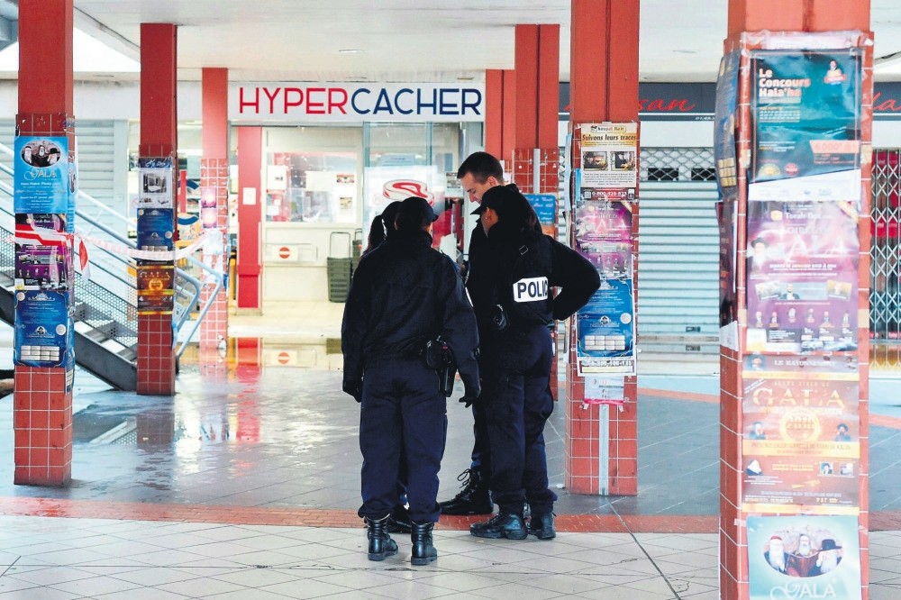 French police stand outside the French kosher grocery store in Creteil, south of Paris, Jan. 9.  