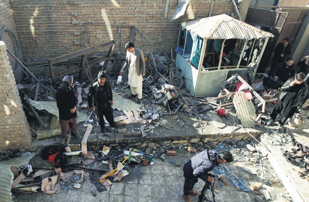 Afghan security officials inspect the scene of a suicide bombing in Kabul, Afghanistan, on Dec. 28, the most recent deadly incident demonstrating the urgency for the Islamic world to unite against terrorism. 