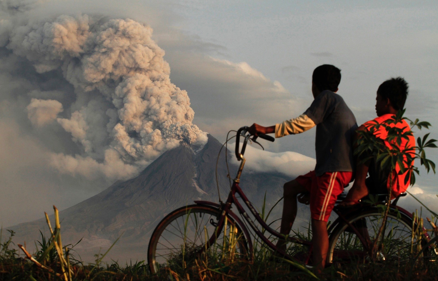 Two local boys look in awe as Mount Merapi erupts in Manisrenggo, Indonesia on Nov. 10, 2010.