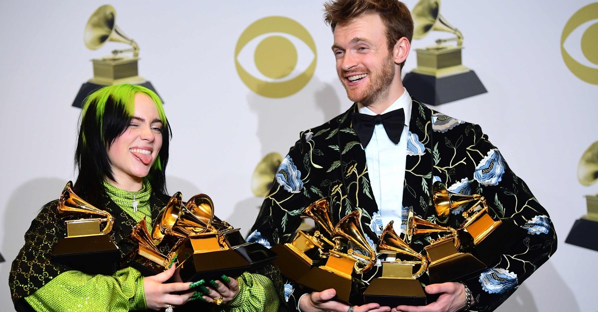 U.S. singer-songwriter Billie Eilish (L) and brother U.S. producer Finneas accept the award for Song Of The Year for ,Bad Guy, during the 62nd Annual Grammy Awards on January 26, 2020, in Los Angeles. (AFP Photo)