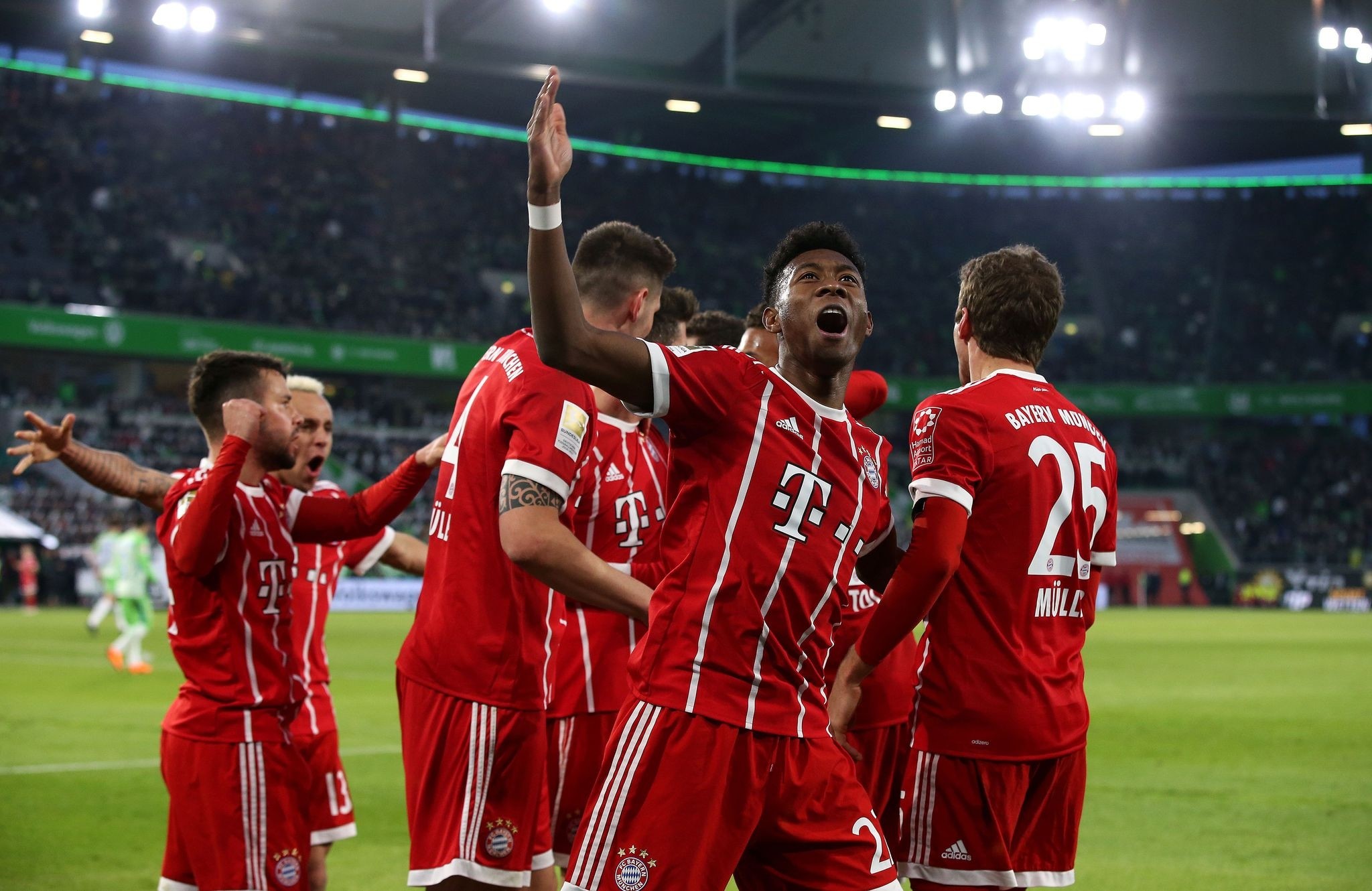 Bayern Munich's Austrian defender David Alaba (C) celebrates with teammates after they scored during the Bundesliga football match between VfL Wolfsburg and FC Bayern Munich on February 17, 2018. (AFP Photo)