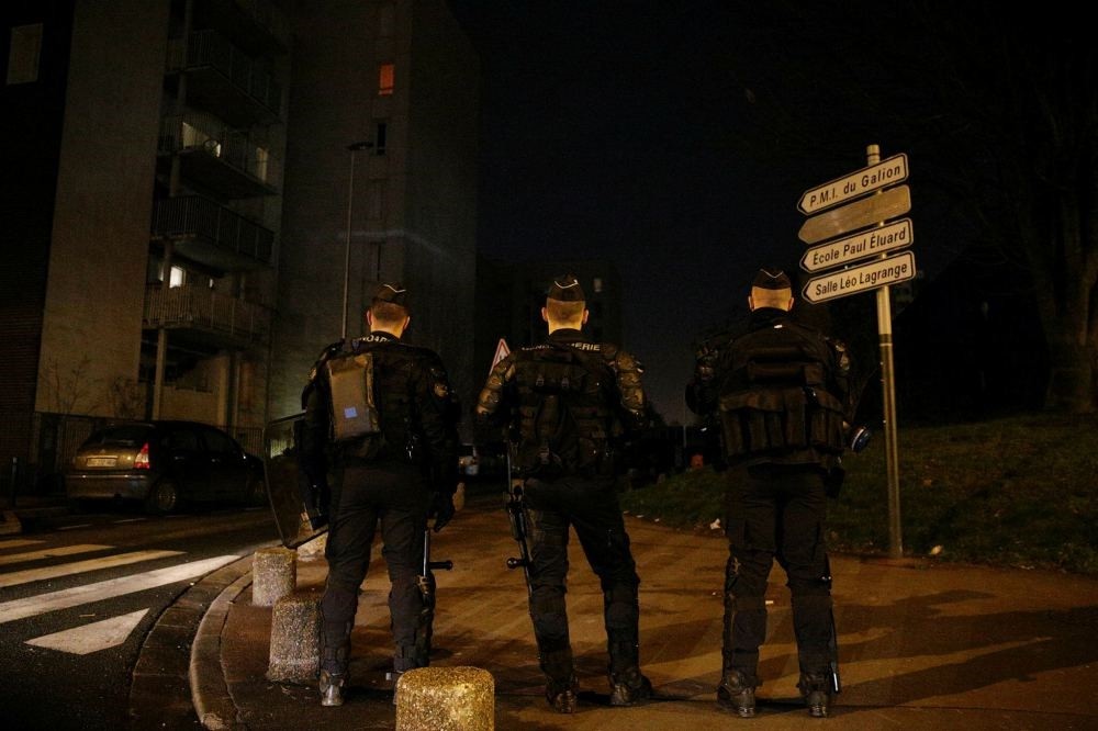 French policemen stand guard at the Rose des Vents district in Aulnay-sous-Bois, northeast of Paris.