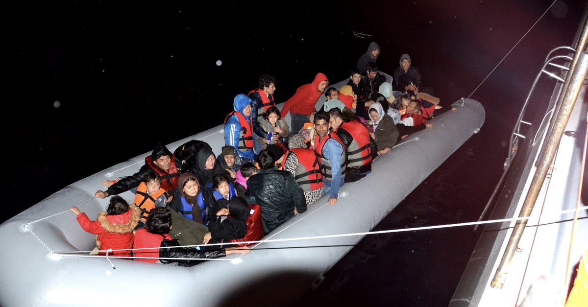 Illegal migrants intercepted at sea being pulled to a Coast Guard boat off the coast of u0130zmir, Oct. 7, 2019.