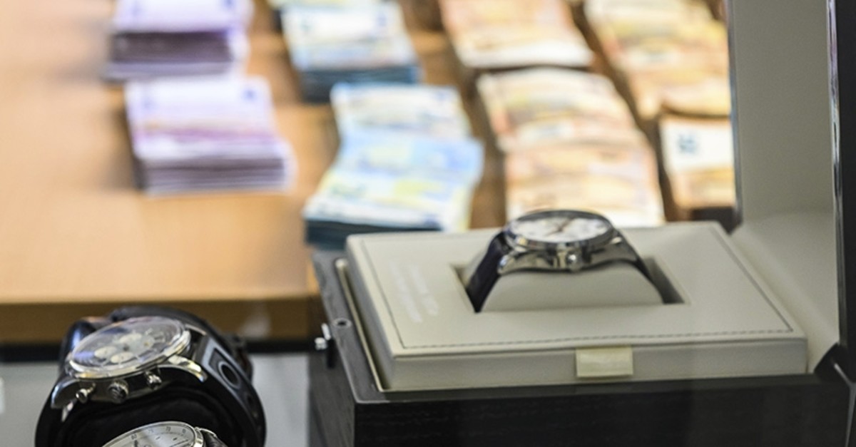 Pieces of evidence like banknotes and luxury watches are presented on Friday, May 3, 2019 at a press conference in Wiesbaden, Germany (AP Photo)
