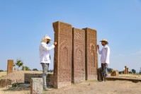 Archaeologists clean up the tombstones at the cemetery.