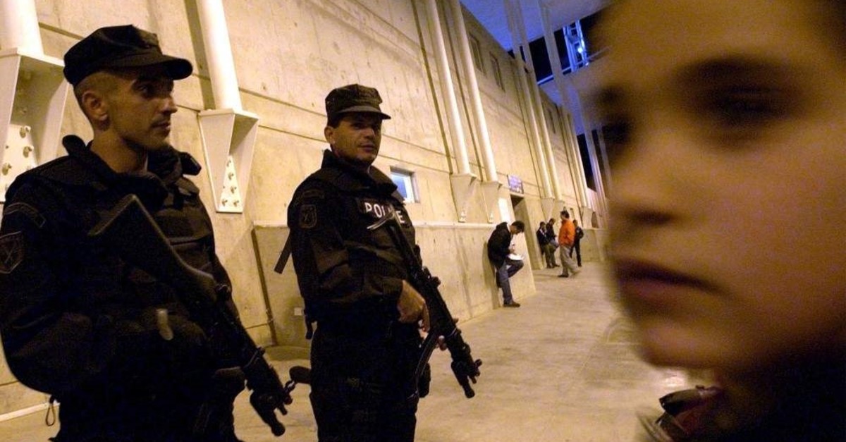 Greek Cypriot special police officers, at left, are deployed in and around the GSP stadium, on Wednesday, Nov. 17, 2004. (AP File Photo)