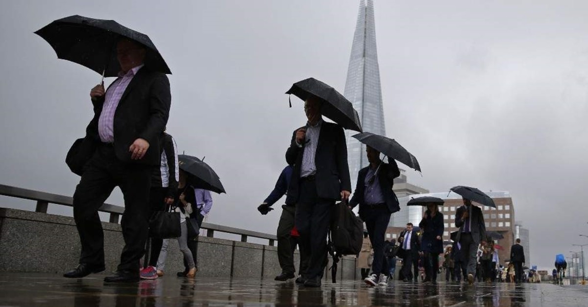 People walk on the London Bridge in London, one of the most populated capitals in the world. AFP 