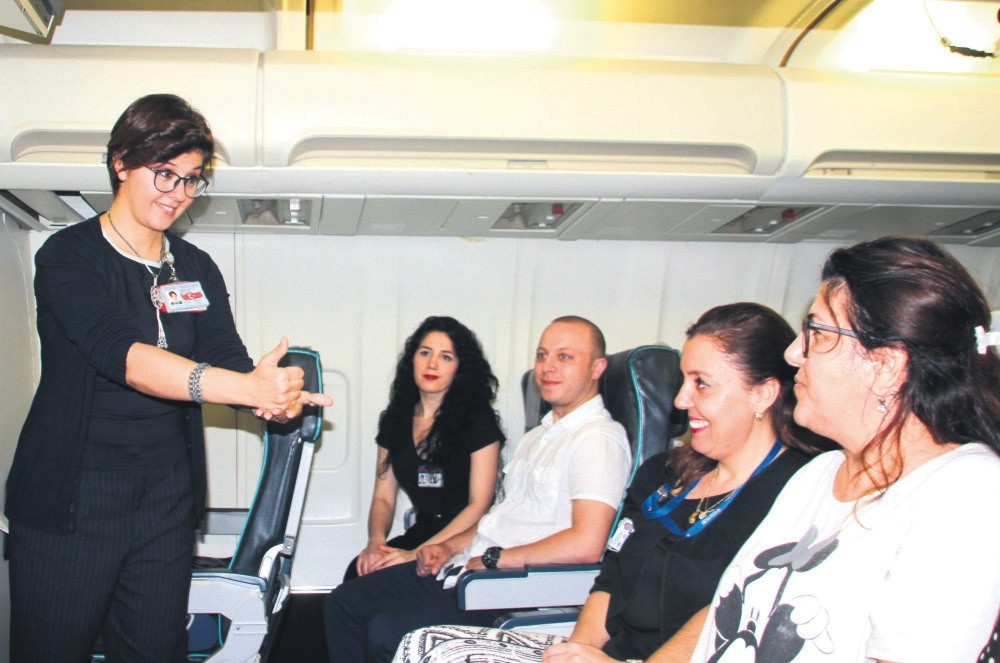Flight attendants demonstrate their sign language skills.