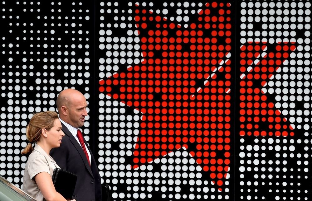 People pass by a National Australia Bank (NAB) branch in Sydney.