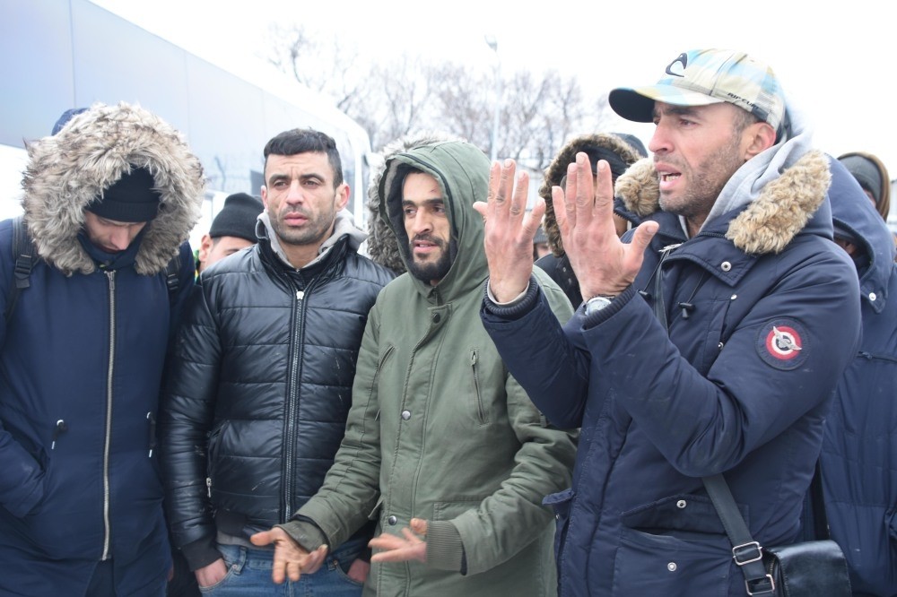 Palestinian migrant Qasim Amin (R), accompanied by other migrants, tells reporters their plight on the Greek side of the border.