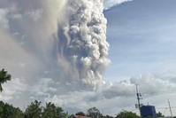 A small volcano near the Philippine capital of Tagaytay that draws tourists for its picturesque setting in a lake erupts with a massive plume of ash and steam Sunday, Jan. 12, 2020. (AP Photo)