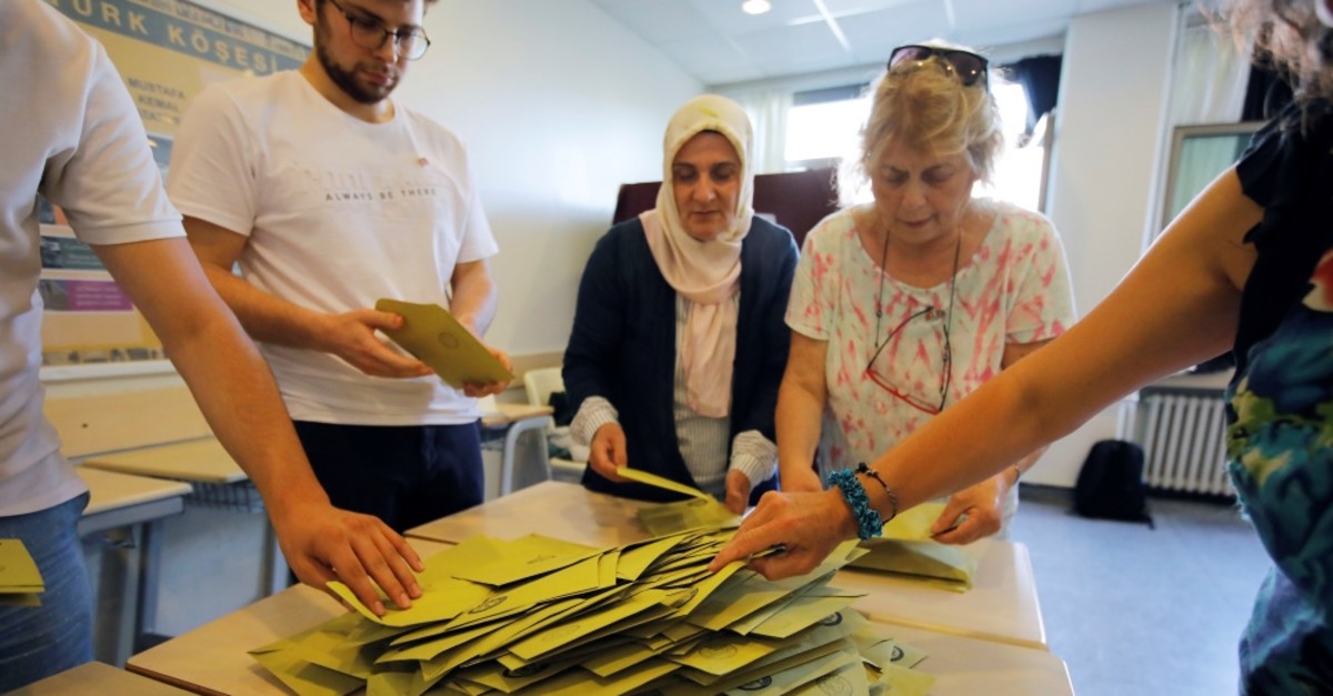 Election officials open a ballot box to count votes at a polling station in Istanbul, June 23, 2019. 