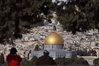 Tourists looking at the panoramic view of Old Jerusalem with the Dome of the Rock seen in the foreground, the Mount of the Olives, Jan. 27, 2020. (AFP)