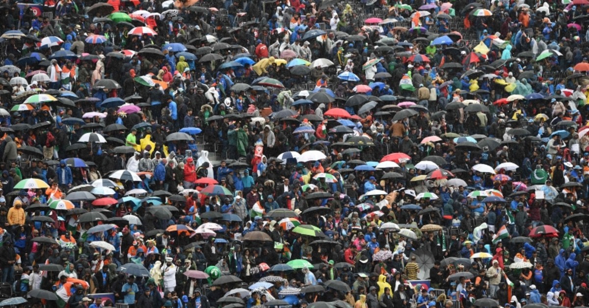 Umbrellas are up in the crowd as rain stops play during the 2019 Cricket World Cup group stage match between India and Pakistan at Old Trafford in Manchester, north-west England, on June 16, 2019. (AFP Photo)
