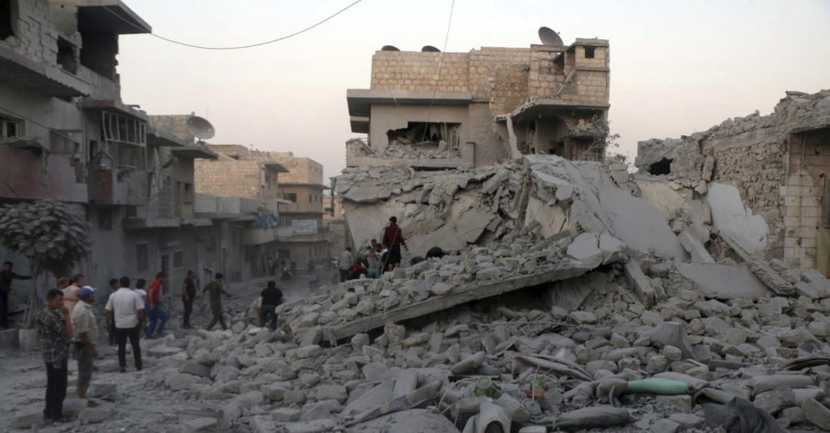 People searching for victims under the rubble of destroyed buildings hit by regime airstrikes in the northern town of Maaret al-Numan, Idlib province, Aug. 28, 2019.