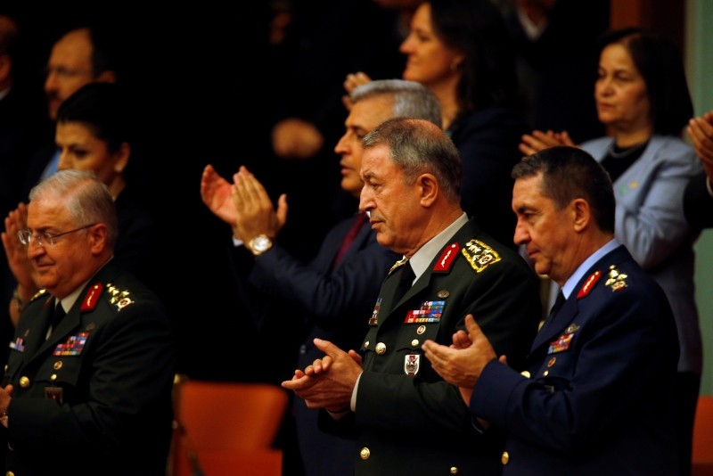 Hulusi Akar, centre, Turkey's Chief of the General Staff, accompanied by other military commanders applaud from the gallery after Erdoğan took the oath of office for his second term as president, at the parliament in Ankara, Turkey, Monday, July 9, 2018