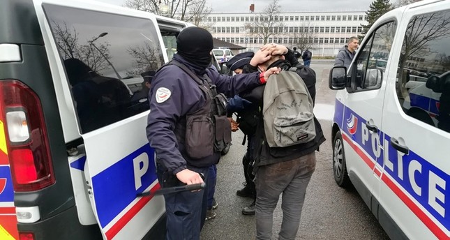Police arrest a student close to the Saint-Exupery high school in Mantes-la-Jolie in the Yvelines, following clashes in which 146 people were arrested on December 6, 2018. (AFP Photo)
