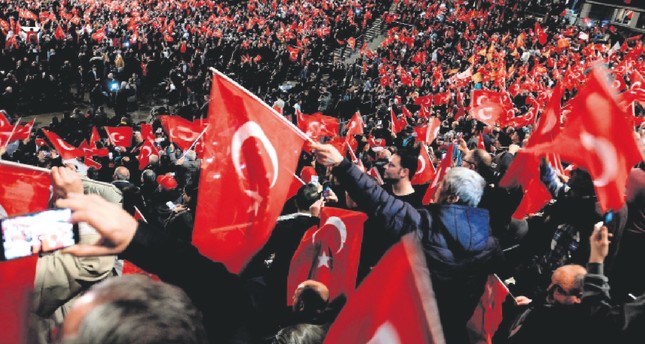Participants wave Turkish flags peacefully during a meeting held in Germany by Turkish Prime Minister Binali Yıldırım in Oberhausen, Feb. 18, 2017.