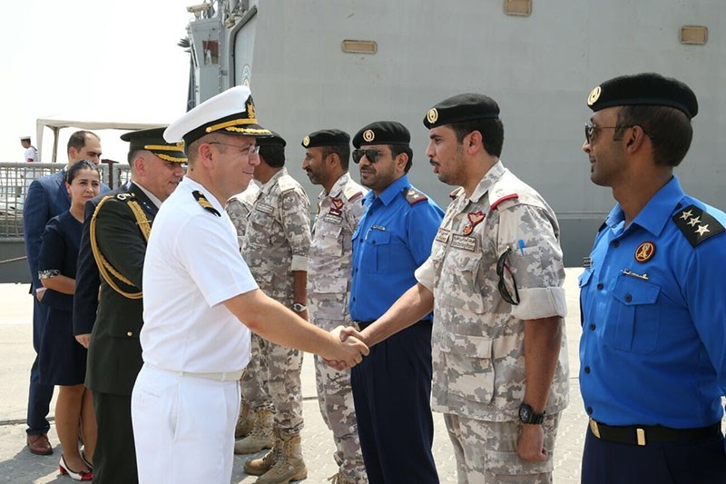 Turkish military officers shake hands with their Qatari counterparts at Hamad Port near Doha, Qatar, August 1, 2017 (AA Photo)